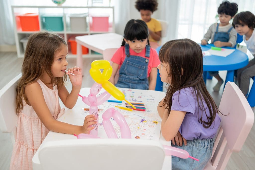 Back to school and summer course. Little children drawing and coloring kindergarten classroom.