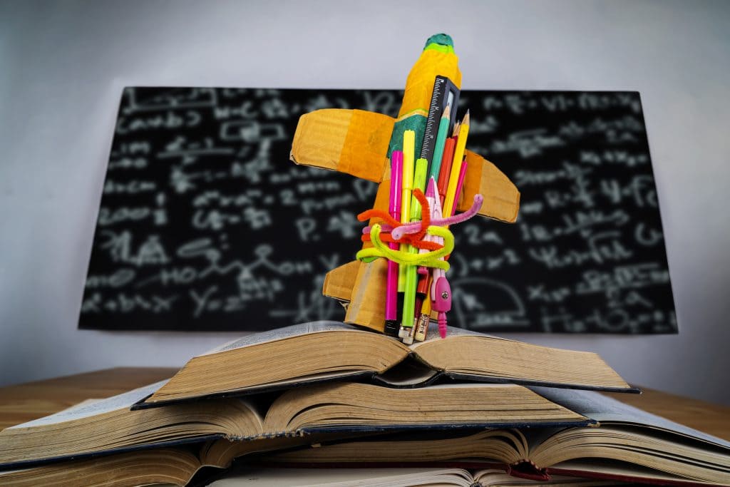 Startup Concept - Creative Rocket With Colorful Pencils And Books On Desk - Back To School