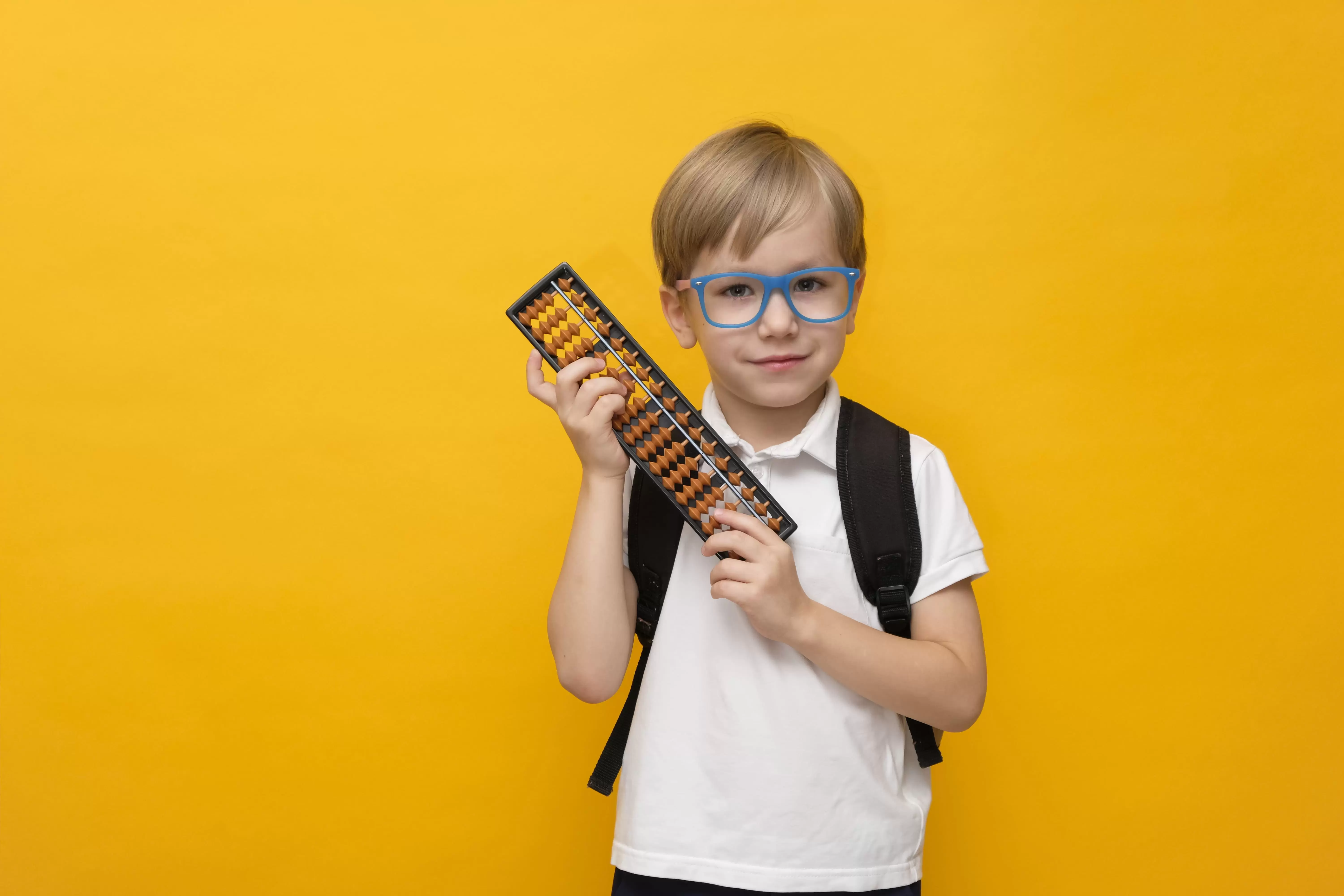 cute little school boy glasses holding abacus mental arithmetic