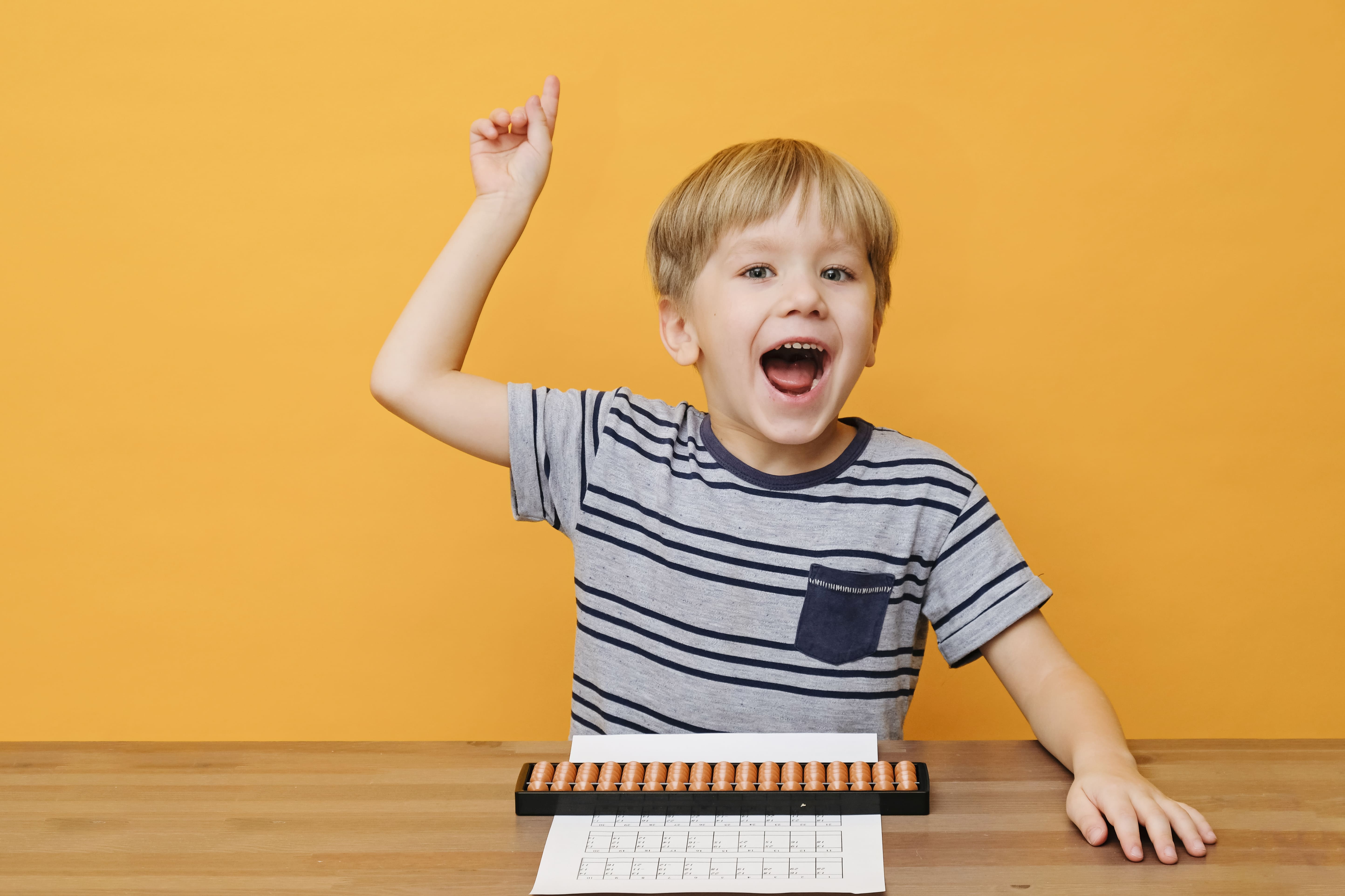 little boy doing simple math exercises with abacus scores mental arithmeric