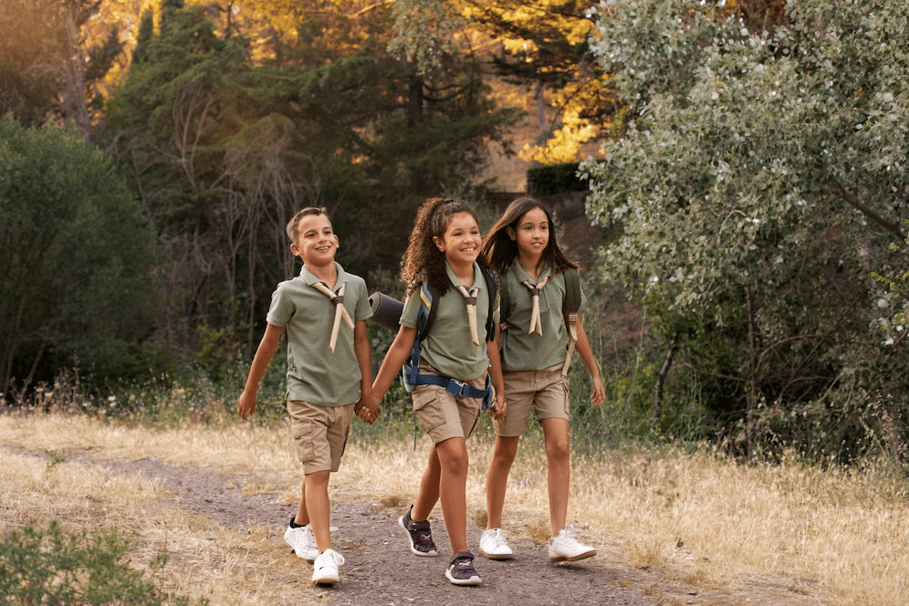Three children doing hiking.