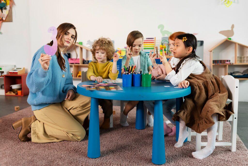 full shot kids sitting together table 1 1 Social Skill Enhancement in kids