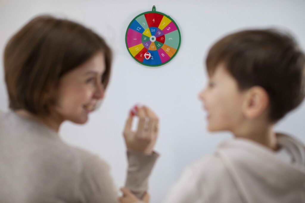 back view mother boy playing game 1 How Balance Shapes Learning in Kids